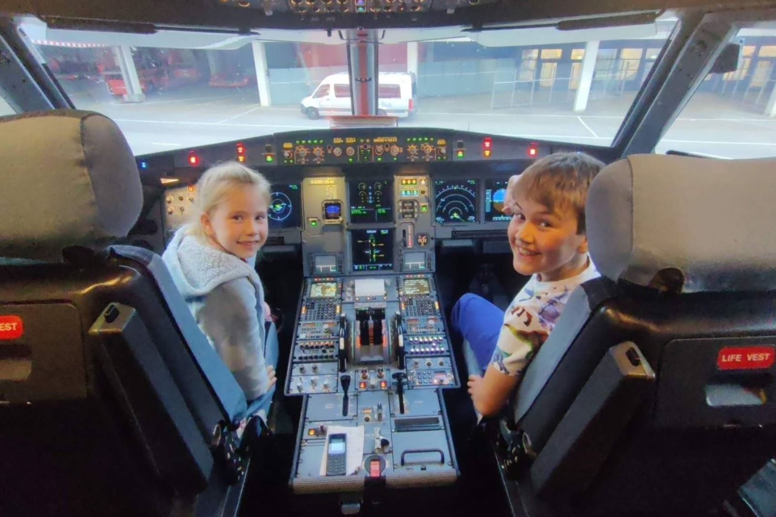 Schoolboy Cooper Wallace and his sister in the cockpit of an aeroplane